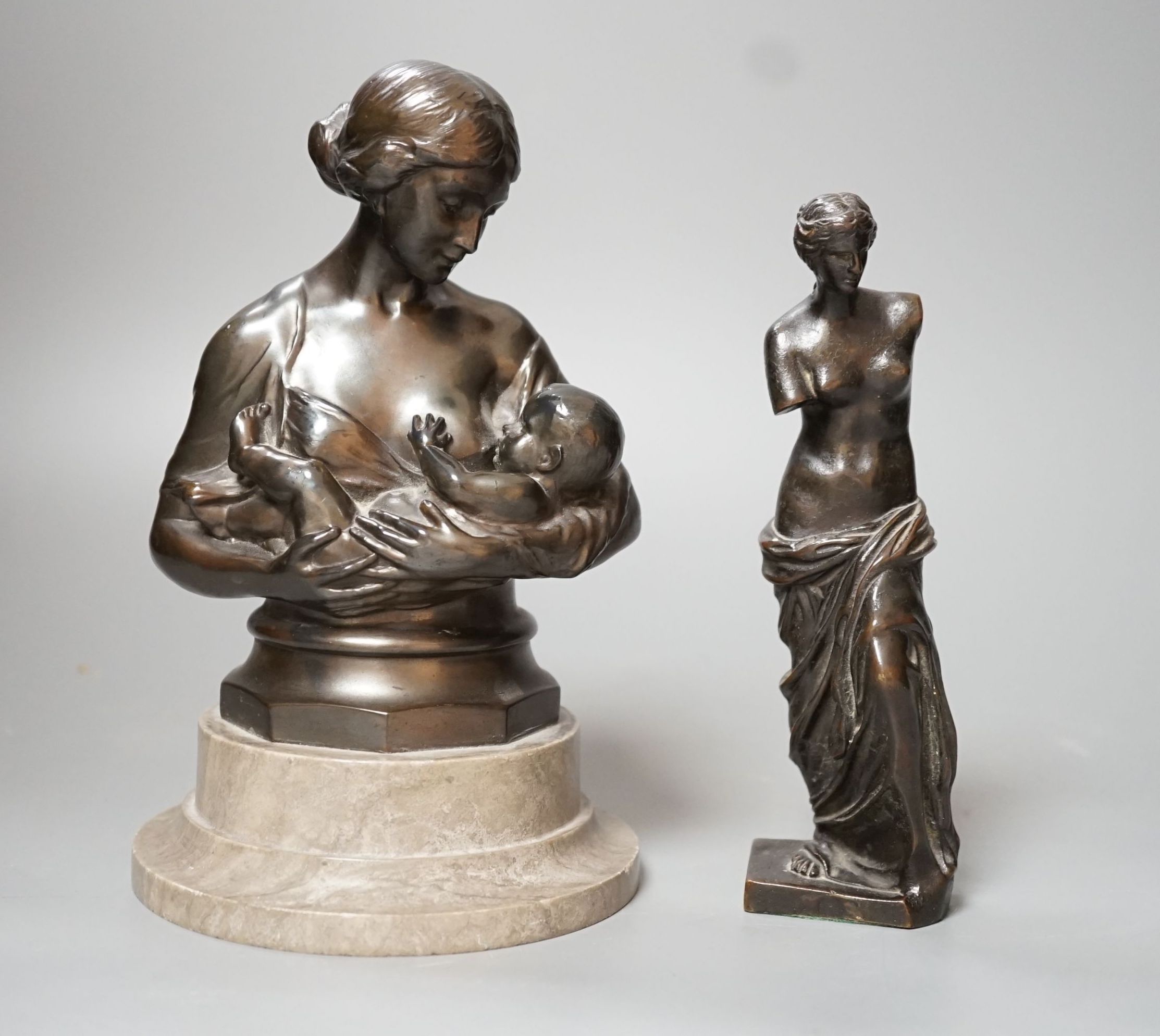 A bronze figure of the Venus de Milo, 16cm, together with another bronze bust of mother and child on plinth base, 19cm